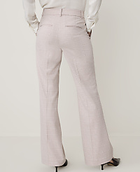 A person wearing light pink plaid flared trousers and a white blouse stands against a plain white background. carousel Product Image 2