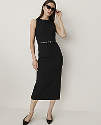 A woman in a black dress and sunglasses stands against a plain white background. carousel Product Image 1