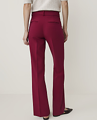 A person wearing burgundy flared trousers and a textured top stands against a plain, light-colored background. carousel Product Image 3