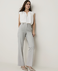 A woman in a white blouse and checkered pants stands against a plain white background. carousel Product Image 1
