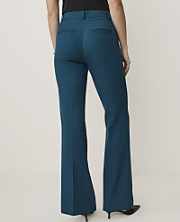 A person wearing teal flared trousers stands against a plain, light-colored background. carousel Product Image 3