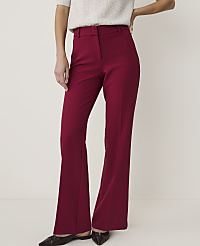 A person in maroon flared trousers and a cream sweater stands against a plain, light background. carousel Product Image 2