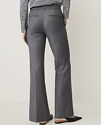 A person wearing gray flared trousers and a patterned shirt stands against a plain, light-colored background. carousel Product Image 3
