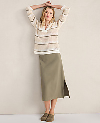 A woman in a striped sweater and olive skirt poses against a plain wall. carousel Product Image 5