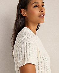 A woman in a cream-colored sweater is shown in profile against a plain, light-colored background. carousel Product Image 2