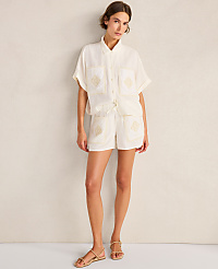 A woman in a cream-colored linen set stands against a textured cream wall. carousel Product Image 4