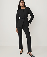 A woman in a black suit stands against a plain white background. carousel Product Image 4