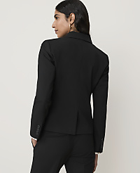 A woman in a black blazer and pants stands against a plain, light-colored background. carousel Product Image 2