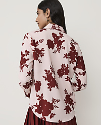 A woman in a light pink floral blouse stands against a blurred background. carousel Product Image 2