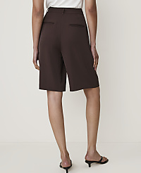 A person wearing brown Bermuda shorts and black heeled sandals stands against a plain white background. carousel Product Image 3