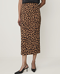 A woman in a leopard print midi skirt and black heels stands against a plain white background. carousel Product Image 2