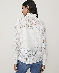 A woman in a white lace blouse and blue jeans stands against a plain white background. carousel Product Image 2