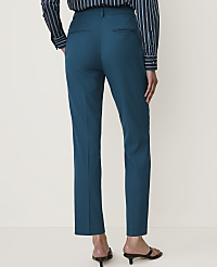 A person wearing teal trousers and a striped shirt stands against a plain white background. carousel Product Image 2