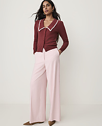 A woman in a maroon cardigan and pink wide-leg pants stands against a plain white background. carousel Product Image 1