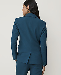 A woman in a teal blazer and pants stands with her back to the camera against a plain white background. carousel Product Image 2