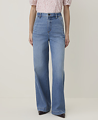 A person in a pink lace top and light blue wide-leg jeans stands against a plain cream background. carousel Product Image 2