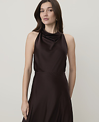 A woman in a dark brown satin dress stands against a plain, light gray background. carousel Product Image 1