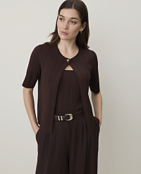 A woman in a brown cardigan and matching top stands against a plain, light-colored background. carousel Product Image 1