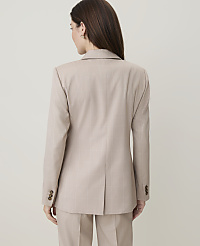 A woman in a beige plaid suit stands against a plain, light-colored background. carousel Product Image 2