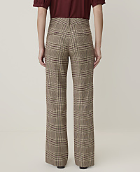 A person wearing plaid wide-leg pants stands against a plain, light-colored background. carousel Product Image 3