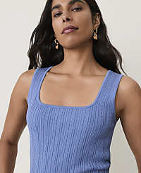 A woman with dark hair and earrings wears a blue cable-knit tank top against a plain background. carousel Product Image 3