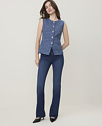 A woman in a blue tweed vest and dark wash flared jeans stands against a plain, light-colored background. carousel Product Image 4