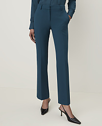 A person stands in teal trousers and black heels against a plain, light background. carousel Product Image 2