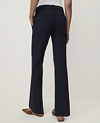 A person wearing dark flared trousers and brown loafers stands against a plain, light-colored background. carousel Product Image 2