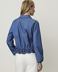 A woman in a blue denim jacket with an embroidered hem stands against a plain white background. carousel Product Image 2