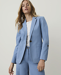 A woman in a blue blazer and pants stands against a plain, light background. carousel Product Image 3