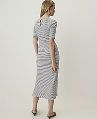 A woman in a striped dress stands against a plain, light-colored background. carousel Product Image 2