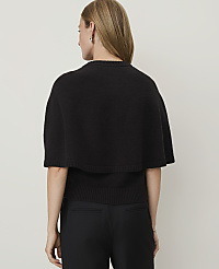 A woman in a black cape sweater and black pants stands against a plain white background. carousel Product Image 2