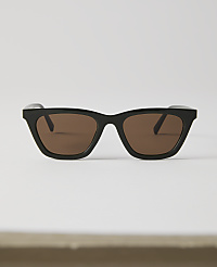 Black-rimmed sunglasses with brown lenses rest on a white surface against a plain white background. carousel Product Image 1