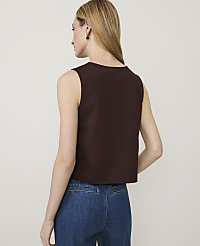 A woman in a brown sleeveless top and blue jeans stands against a plain white background. carousel Product Image 2