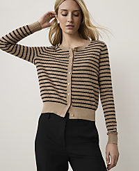 A woman in a striped cardigan and black pants stands against a plain, light background. carousel Product Image 1