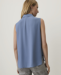 A woman in a blue sleeveless blouse and plaid pants stands against a plain white background. carousel Product Image 2
