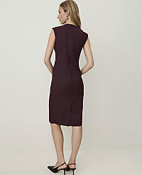 A woman in a burgundy sheath dress and black heels stands against a plain, light-colored background. carousel Product Image 2