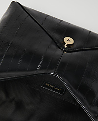 A glossy black clutch with a gold snap closure is laid open against a plain white background. carousel Product Image 2