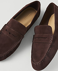 A pair of dark brown suede loafers with visible stitching rests on a plain white background. carousel Product Image 1