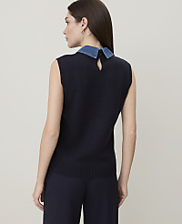 A woman in a dark blue sleeveless sweater with a denim collar stands against a plain, light-colored background. carousel Product Image 2