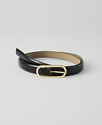A black, glossy belt with a gold oval buckle lies coiled on a plain white background. carousel Product Image 1
