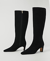 A pair of black suede knee-high boots with pointed toes and block heels stand on a white background. carousel Product Image 2