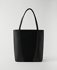 A sleek black tote bag with a V-shaped seam stands against a plain white background. carousel Product Image 1