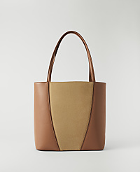 A brown and tan leather tote bag with a light gray background. carousel Product Image 1