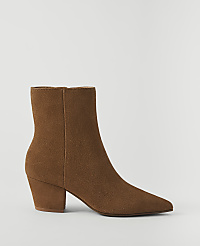 A brown suede ankle boot with a pointed toe and block heel stands against a plain white background. carousel Product Image 1