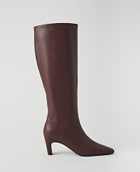 A single maroon leather knee-high boot with a pointed toe and a stiletto heel stands against a plain white background. carousel Product Image 1