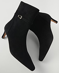 A pair of black suede ankle boots with a buckle detail are displayed against a plain white background. carousel Product Image 2