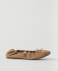 A tan suede ballet flat with a small bow sits on a plain white background. carousel Product Image 2