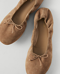 Two tan suede ballet flats with bows are arranged on a light gray background. carousel Product Image 1
