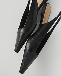 Two black slingback heels with a textured finish are angled against a plain white background. carousel Product Image 2